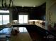 The kitchen has custom cabinets, stainless steel appliances, and a large island at 5889 Thistle Meadow Ave, Las Vegas, NV 89139