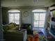 Bright living room featuring large windows with outside views, a colorful rug, and a fireplace at 5889 Thistle Meadow Ave, Las Vegas, NV 89139