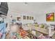 Spacious living room with modern decor, wood floors, and seamless transitions to the kitchen and dining areas at 5889 Thistle Meadow Ave, Las Vegas, NV 89139