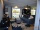 Comfortable living room with a large window overlooking the backyard and modern décor at 5889 Thistle Meadow Ave, Las Vegas, NV 89139
