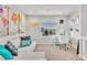 Cozy upstairs loft featuring a sofa, desk, and an abundance of natural light from the large window at 5889 Thistle Meadow Ave, Las Vegas, NV 89139