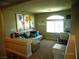 Cozy loft area with comfortable seating, a desk, and natural light from a window at 5889 Thistle Meadow Ave, Las Vegas, NV 89139