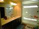 Modern bathroom with dual sinks, a glass-enclosed shower, and updated fixtures at 5889 Thistle Meadow Ave, Las Vegas, NV 89139
