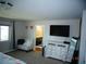 Spacious main bedroom boasting a sitting area, wall-mounted TV, and ensuite access at 5889 Thistle Meadow Ave, Las Vegas, NV 89139