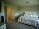 Bright main bedroom featuring a floral bedding set, a vanity, and an ensuite entry way at 5889 Thistle Meadow Ave, Las Vegas, NV 89139