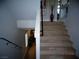 Carpeted staircase with dark wood railing leading to the upper level of the home at 5889 Thistle Meadow Ave, Las Vegas, NV 89139