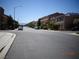 Street view of a residential neighborhood with well-maintained homes and street parking under a clear sky at 5889 Thistle Meadow Ave, Las Vegas, NV 89139