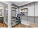 Organized walk-in closet with adjustable shelving, hanging space, and wood-look flooring at 5889 Thistle Meadow Ave, Las Vegas, NV 89139