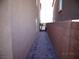 Side walkway with brick pavers, a gate, and a textured wall at 5889 Thistle Meadow Ave, Las Vegas, NV 89139