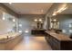 Spacious bathroom with double vanity, soaking tub, mosaic tile wall, and modern fixtures at 6 Yorkridge Ct, Henderson, NV 89052