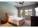 Bright bedroom featuring a ceiling fan, neutral tones, carpet floors, and exterior access at 6 Yorkridge Ct, Henderson, NV 89052
