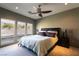 Comfortable bedroom with plush bedding, ceiling fan, and large windows offering hillside views at 6 Yorkridge Ct, Henderson, NV 89052
