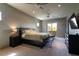 Spacious bedroom with a ceiling fan, balcony access, dark furniture, and a comfortable king bed at 6 Yorkridge Ct, Henderson, NV 89052