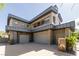 Contemporary home featuring an attached three-car garage and stone accents at 6 Yorkridge Ct, Henderson, NV 89052