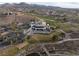 Aerial view of golf course, club house and lush surrounding landscape at 6 Yorkridge Ct, Henderson, NV 89052