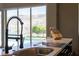 Modern kitchen sink with a view of the pool and lush greenery at 6 Yorkridge Ct, Henderson, NV 89052