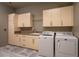 Bright laundry room with plenty of cabinet storage and a granite countertop for folding clothes and supplies at 6 Yorkridge Ct, Henderson, NV 89052