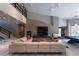 Spacious living room with high ceilings, modern fireplace, and a comfortable sectional sofa and game room at 6 Yorkridge Ct, Henderson, NV 89052