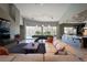 Open-concept living room with a pool table, modern fireplace, and ample natural light at 6 Yorkridge Ct, Henderson, NV 89052