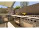 Outdoor kitchen with stainless steel appliances, grill, and a granite countertop at 6 Yorkridge Ct, Henderson, NV 89052