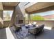 Inviting outdoor patio with fireplace, modern seating, and scenic views at 6 Yorkridge Ct, Henderson, NV 89052