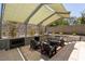 Inviting outdoor kitchen with a fireplace, BBQ grill, and comfortable seating at 6 Yorkridge Ct, Henderson, NV 89052