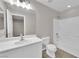 Bright bathroom with a white single sink vanity and a tub with white tile surround at 6284 Anticline Ave, Las Vegas, NV 89139