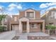 Inviting two-story home with a cozy front porch and charming architectural details at 6284 Anticline Ave, Las Vegas, NV 89139