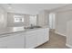 Bright kitchen with stainless steel sink, white cabinetry, and wood-look tile flooring at 6284 Anticline Ave, Las Vegas, NV 89139
