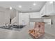 Clean bright kitchen featuring all white cabinets and appliances ready for the new owners at 6284 Anticline Ave, Las Vegas, NV 89139