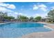 Community pool with clear blue water and shaded seating area at 6284 Anticline Ave, Las Vegas, NV 89139