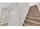 Carpeted staircase leading to the upper level of the home, showcasing neutral tones at 6284 Anticline Ave, Las Vegas, NV 89139