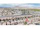 Community aerial view showcasing the neighborhood layout and the stunning mountain backdrop in the distance at 6387 Azurelyn Ave, Las Vegas, NV 89122