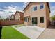 Well-manicured backyard featuring a concrete patio, artificial turf, and seamless access to the home's interior at 6387 Azurelyn Ave, Las Vegas, NV 89122