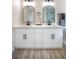 Bathroom featuring a double vanity with black fixtures and marble countertops at 6387 Azurelyn Ave, Las Vegas, NV 89122