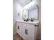 Modern bathroom featuring double sinks, white cabinets, and black hardware for a sleek look at 6387 Azurelyn Ave, Las Vegas, NV 89122