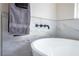 Close up of modern tub and faucet with large marble look tile at 6387 Azurelyn Ave, Las Vegas, NV 89122