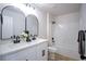Bright bathroom features double sinks, white cabinets, and a shower-tub combination at 6387 Azurelyn Ave, Las Vegas, NV 89122