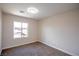 Bright bedroom with a large window and neutral carpet creates a welcoming and comfortable space at 6387 Azurelyn Ave, Las Vegas, NV 89122