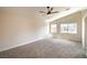 Bright, carpeted bedroom offers lots of space and features two windows for natural light at 6387 Azurelyn Ave, Las Vegas, NV 89122