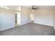 Spacious bedroom with neutral carpet, ceiling fan, and white trim at 6387 Azurelyn Ave, Las Vegas, NV 89122