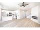 Open-concept living room featuring modern furnishings, white cabinets, and an electric fireplace at 6387 Azurelyn Ave, Las Vegas, NV 89122