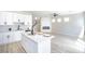 Bright open living space featuring a fireplace, modern white cabinets, and a central kitchen island at 6387 Azurelyn Ave, Las Vegas, NV 89122