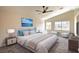 Comfortable main bedroom featuring a ceiling fan, plush carpet and two large windows at 6387 Azurelyn Ave, Las Vegas, NV 89122