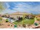 Aerial view of the backyard showing lush artificial turf, patio area, mature trees, and landscaping for outdoor enjoyment at 6688 Martinsville Pl, Las Vegas, NV 89110