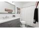 Updated bathroom featuring a gray vanity, modern mirror, and clean, bright interior at 6688 Martinsville Pl, Las Vegas, NV 89110