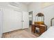 Charming bedroom featuring hardwood floors, a vintage vanity, and an ensuite bathroom at 6688 Martinsville Pl, Las Vegas, NV 89110