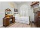 Comfortable bedroom featuring decor, a bright shuttered window and vintage furniture at 6688 Martinsville Pl, Las Vegas, NV 89110