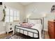 Inviting bedroom featuring a cozy bed, window shutters, and a decorative interior at 6688 Martinsville Pl, Las Vegas, NV 89110