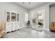 Bright dining area with sliding glass doors to the patio, white china cabinet, and neutral decor, creating a relaxing atmosphere at 6688 Martinsville Pl, Las Vegas, NV 89110